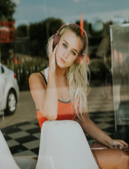 A girl listening to music and watching the road