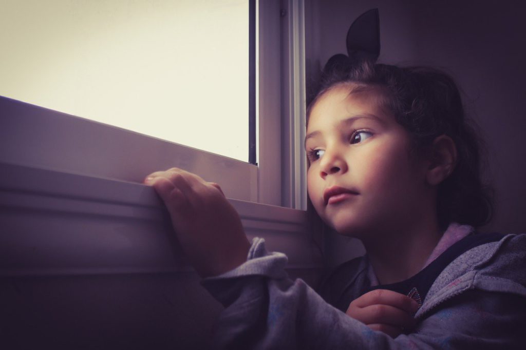 A child by the window thinking