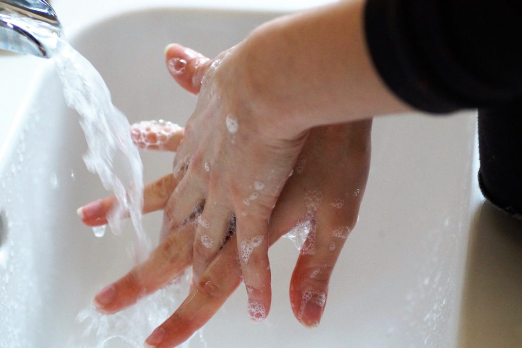 Woman washes her hands thoroughly