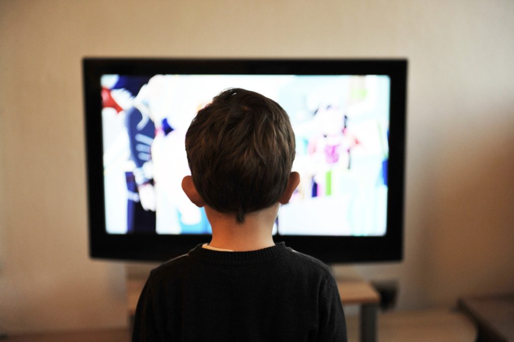 A kid stares at TV show