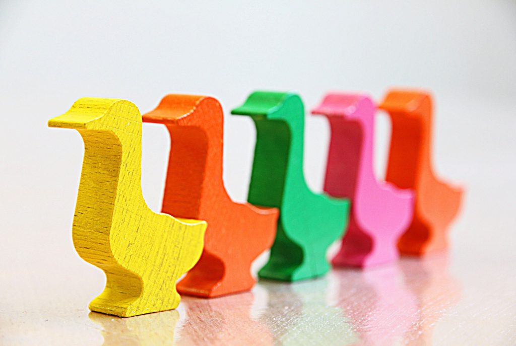 Wooden, colorful, little ducks in a row