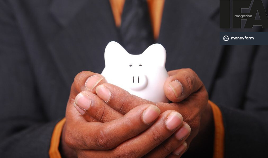 A person holding a money savings pot